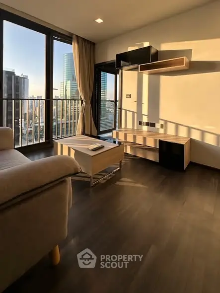 Modern living room with large windows and city view, featuring sleek furniture and warm lighting.