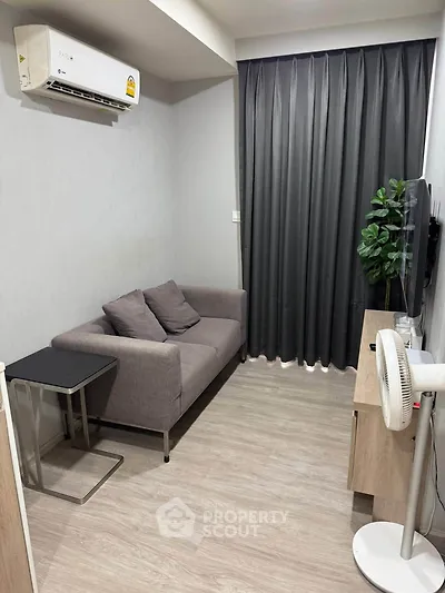 Cozy living room with modern sofa, air conditioning, and stylish decor