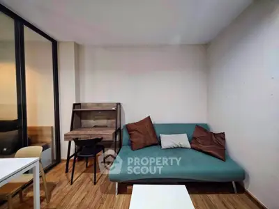Cozy living room with modern sofa and stylish wooden desk, perfect for urban living.