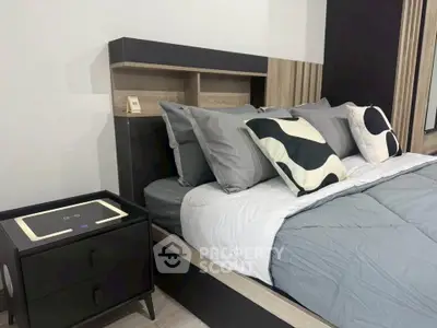 Modern bedroom with stylish bed and nightstand, featuring elegant decor and cozy ambiance.