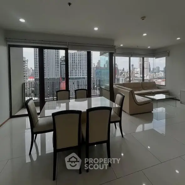 Spacious living room with city view and elegant dining area