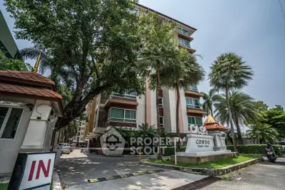 Stunning condo building with lush greenery and modern architecture in a prime location.