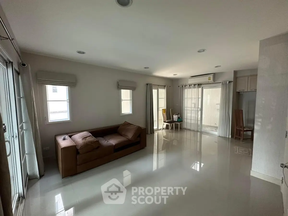 Spacious living room with modern decor and ample natural light