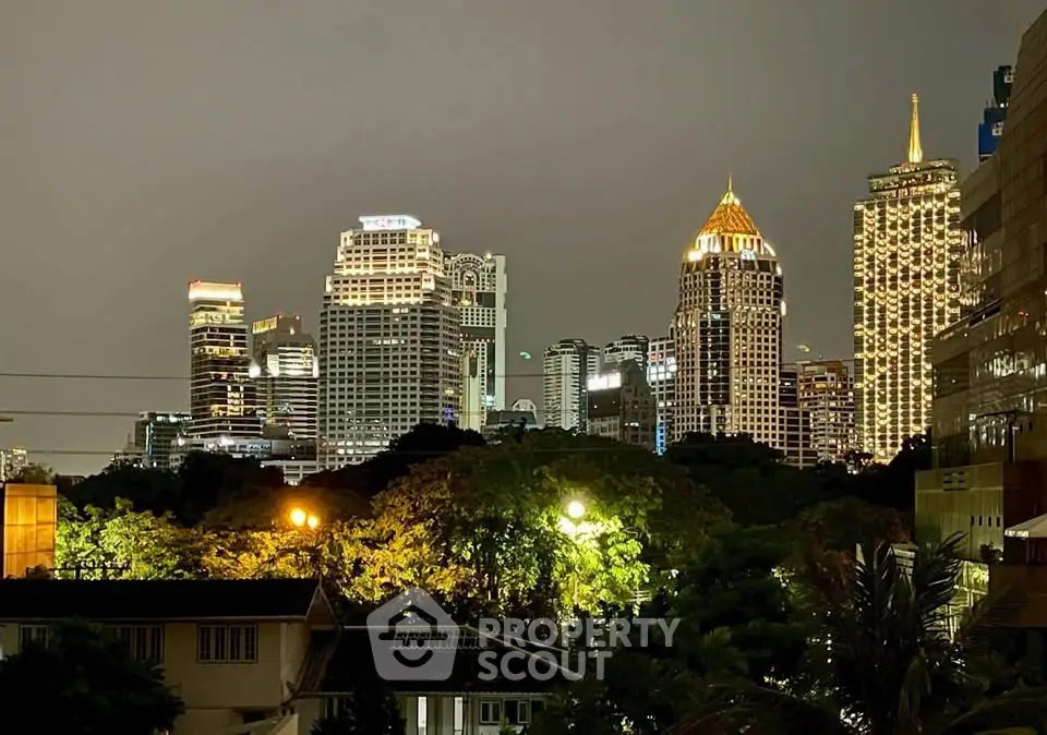 Stunning city skyline view with illuminated skyscrapers at night, showcasing urban luxury and vibrant city life.