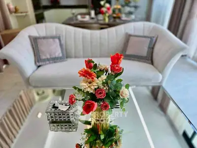 Elegant living room with stylish sofa and floral centerpiece, perfect for modern home decor.