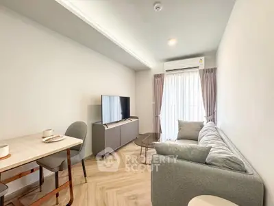 Modern living room with sleek furniture and natural light, perfect for relaxation and entertainment.
