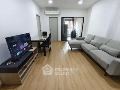 Modern living room with sleek furniture and entertainment setup, perfect for relaxation and gatherings.