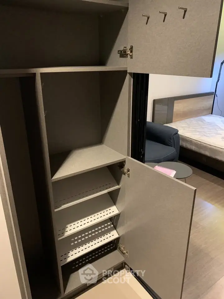 Modern bedroom with open storage cabinet and sleek design