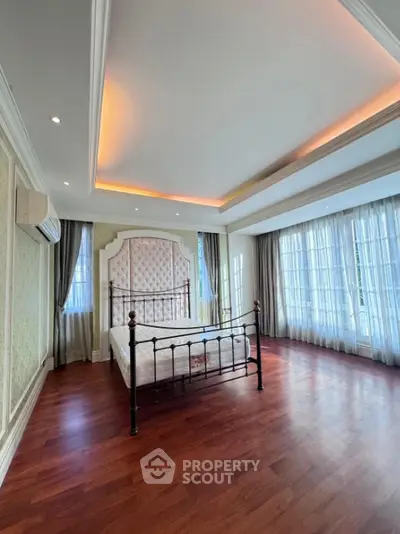 Luxurious bedroom with elegant design and large windows for natural light.
