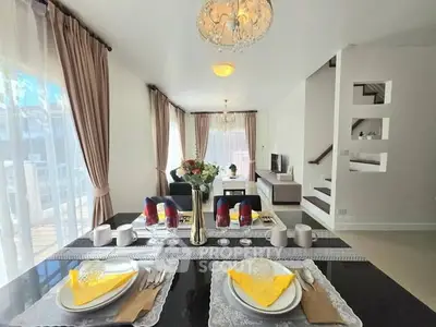 Elegant open-plan living and dining area with stylish decor and natural light.
