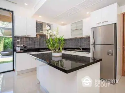 Modern kitchen with sleek black countertops and stainless steel appliances