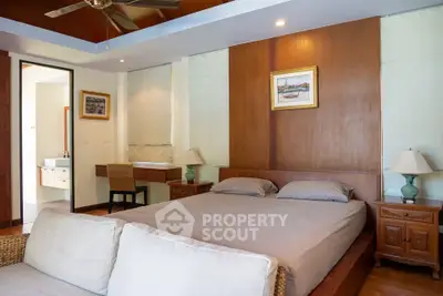Spacious bedroom with elegant decor and ensuite bathroom in luxury home