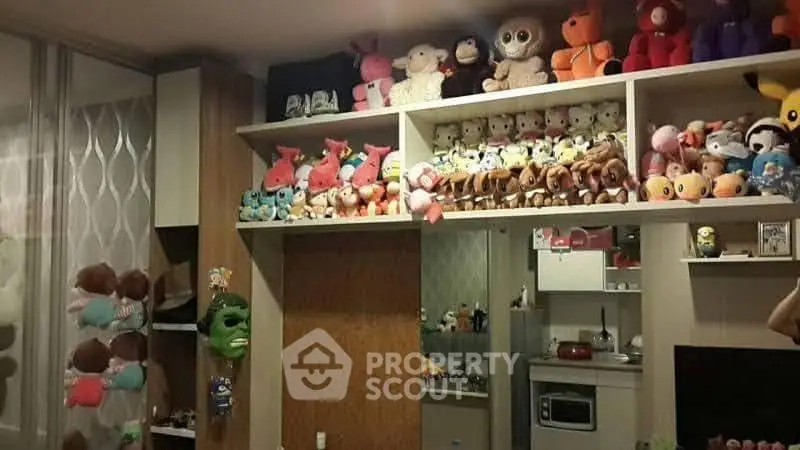 Charming living space with plush toy collection and cozy kitchen area.