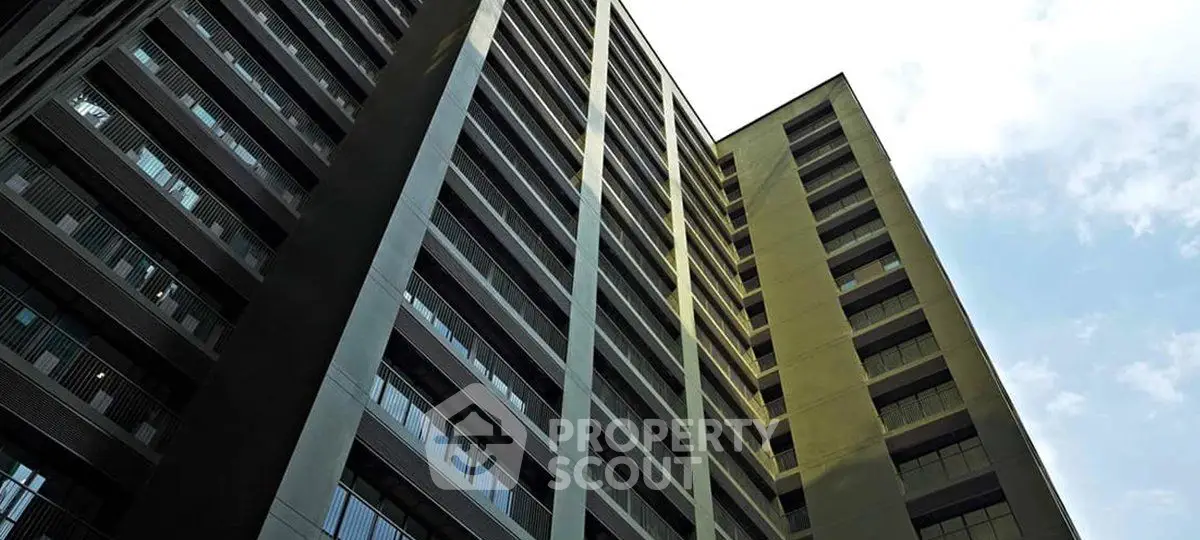 Modern high-rise building with sleek architectural design and expansive windows.