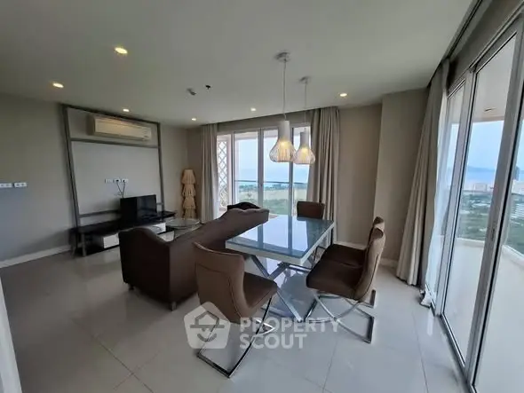 Modern living room with glass dining table and stunning city view