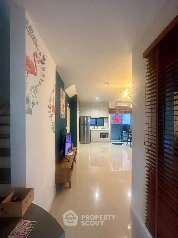 Modern open-plan living area with stylish decor and sleek kitchen appliances.