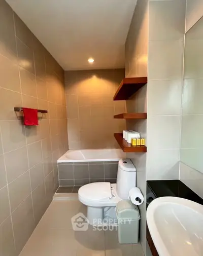 Modern bathroom with sleek design and built-in bathtub, ideal for relaxation.