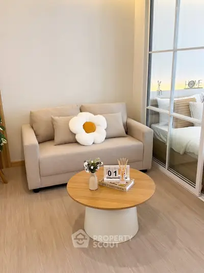 Cozy living room with beige sofa and modern decor, perfect for relaxation.
