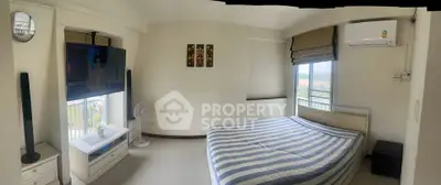 Spacious bedroom with panoramic window and modern decor in a high-rise apartment.