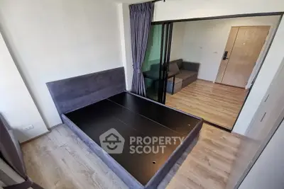 Modern bedroom with sliding glass doors and wooden flooring