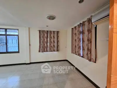 Spacious unfurnished room with tiled flooring and large windows, perfect for customization.