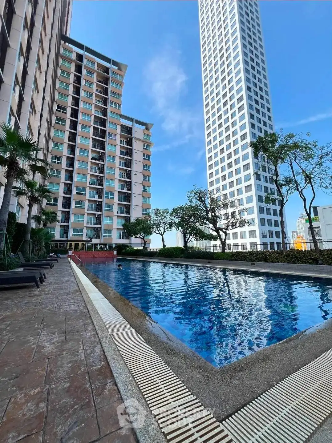 Luxurious high-rise apartment with stunning pool and modern architecture.