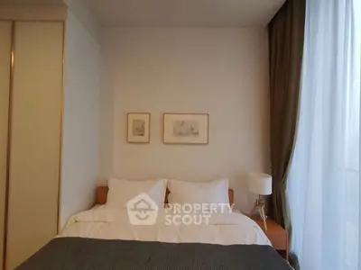 Cozy bedroom with elegant decor and large window for natural light