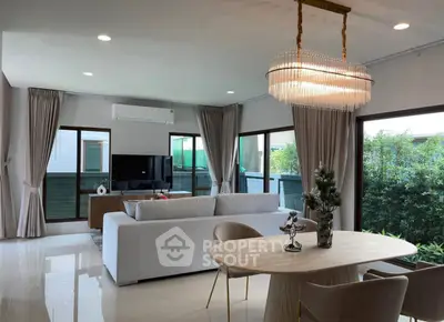 Spacious modern living room with elegant chandelier and large windows