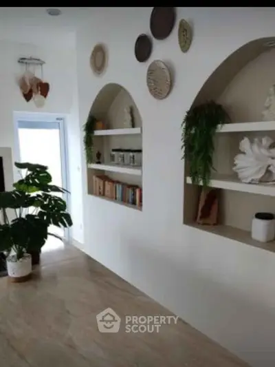 Stylish living room with built-in shelves and decorative plants