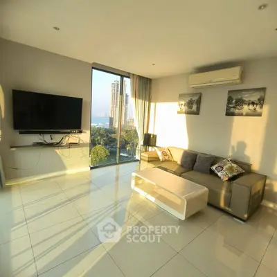 Modern living room with large windows and city view, featuring sleek furniture and wall-mounted TV.