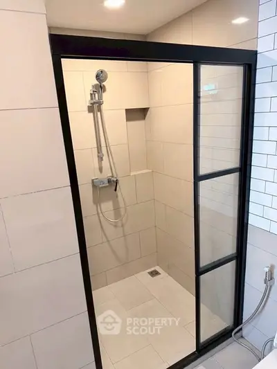 Modern bathroom with sleek glass shower enclosure and contemporary fixtures.