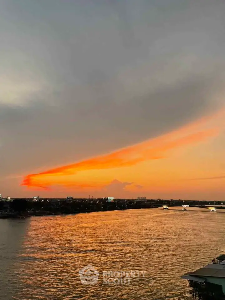 Stunning sunset view over a serene river, perfect for waterfront property listings.
