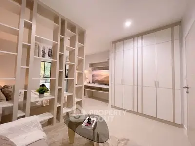 Modern living room with stylish shelving and built-in storage cabinets