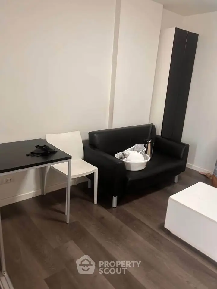 Modern living room with sleek black sofa and minimalist decor