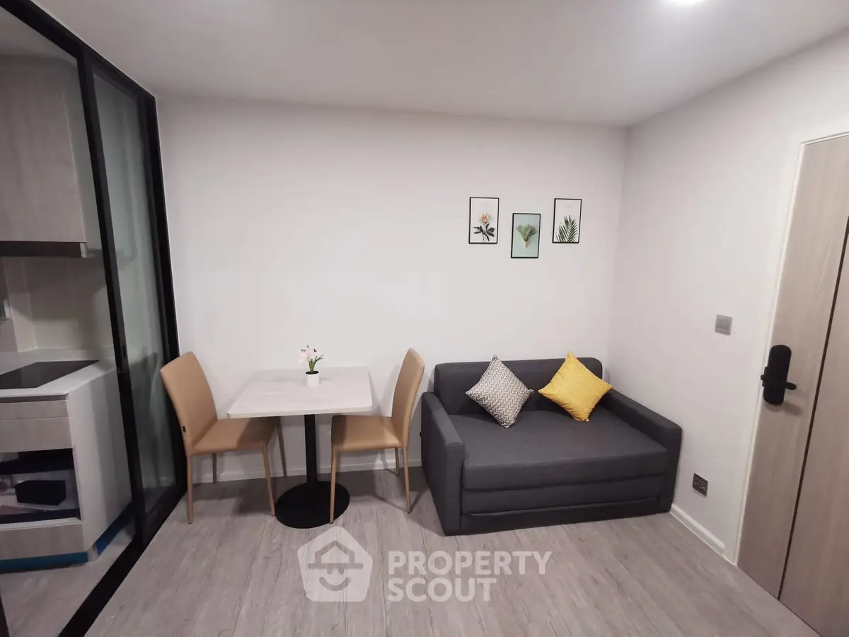 Modern living room with cozy sofa and dining area in stylish apartment.