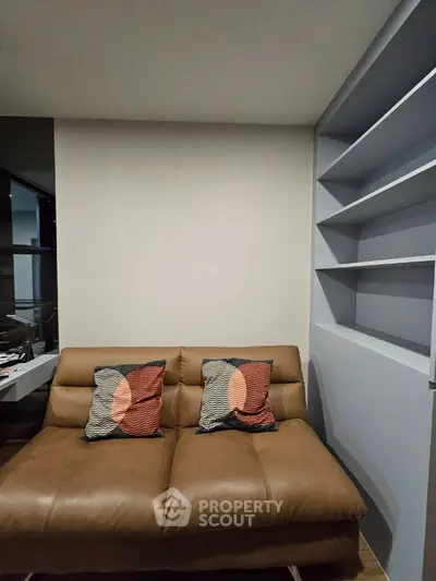 Modern living room with stylish brown sofa and built-in shelves