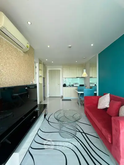 Modern living room with vibrant red sofa and stylish decor
