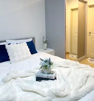 Cozy bedroom with plush bedding and elegant decor for a serene retreat.