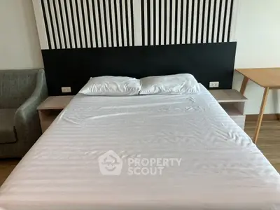 Modern bedroom with stylish headboard and cozy bed in a contemporary apartment.