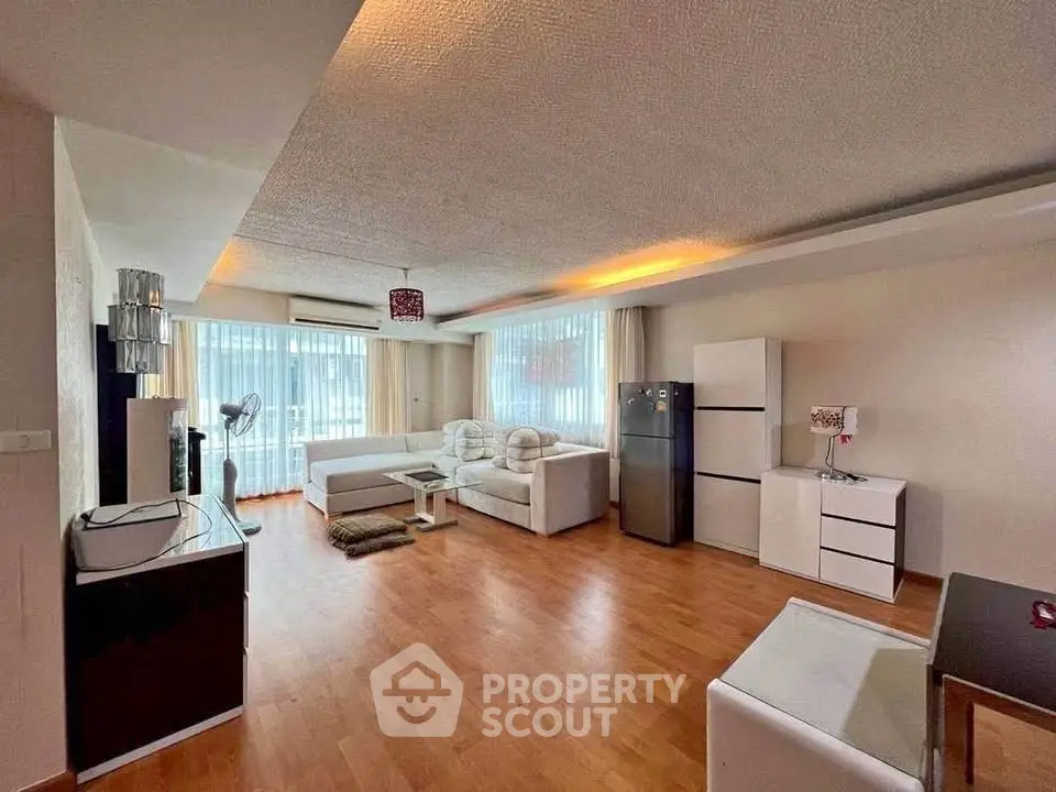Spacious modern living room with elegant decor and ample natural light.