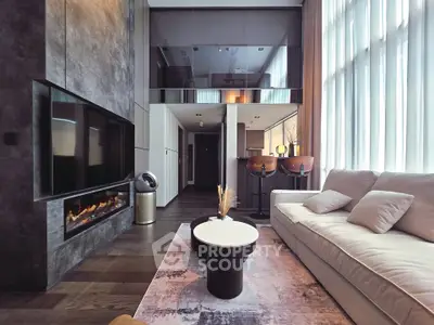 Luxurious modern living room with high ceilings, elegant fireplace, and stylish decor.