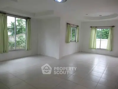 Spacious empty room with large windows and tiled floor, perfect for customization.