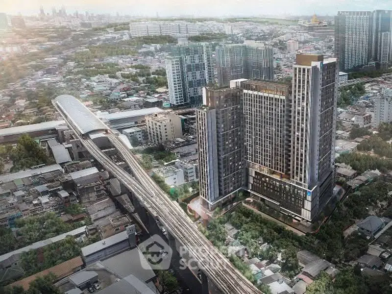 Stunning aerial view of modern high-rise buildings near urban transit line, ideal for city living.