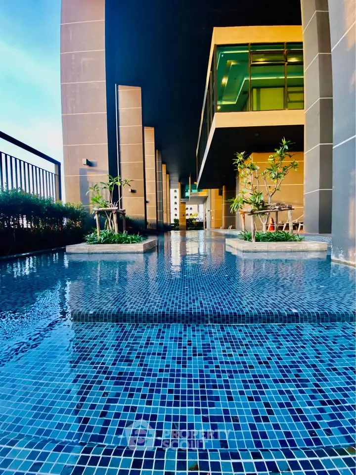 Luxurious modern building exterior with elegant poolside and stylish architecture.