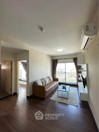 Spacious living room with modern decor and large windows offering natural light.