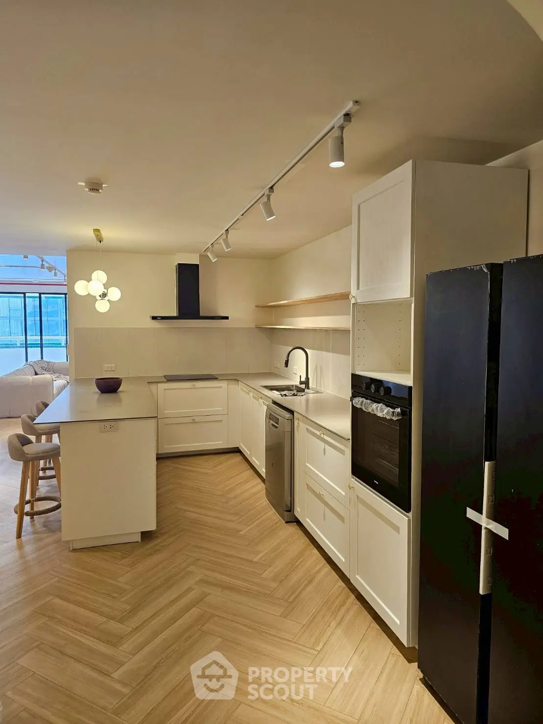 Modern kitchen with sleek appliances and open layout in a stylish apartment