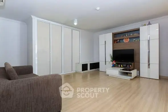 Spacious living room with modern furniture and ample storage space