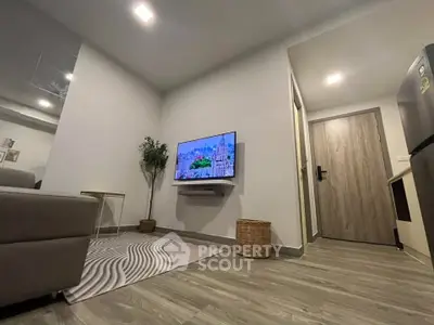 Modern living room with sleek design, featuring a wall-mounted TV and stylish decor.