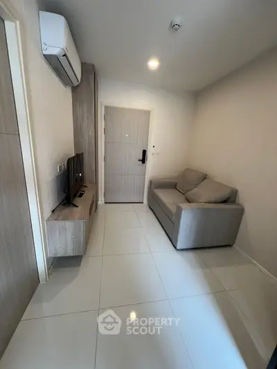 Modern compact living room with sleek furniture and air conditioning