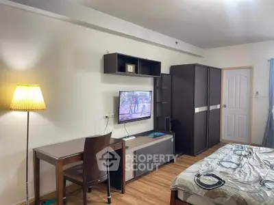 Cozy bedroom with modern furniture and wall-mounted TV, perfect for relaxation and entertainment.